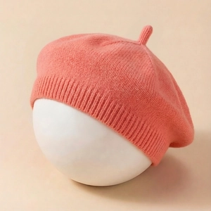 Chic knit baby beret in salmon pink with ribbed edge and classic top stem detail