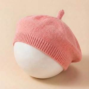 Detail of pink knitted baby beret showing the soft texture and ribbed knit edge detail