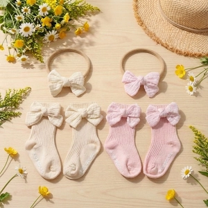 Newborn cotton bow sock and headband set in pink and beige on wooden background