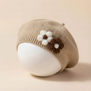 Detail of baby knit beret with 3D crochet flowers and soft ribbed texture trim