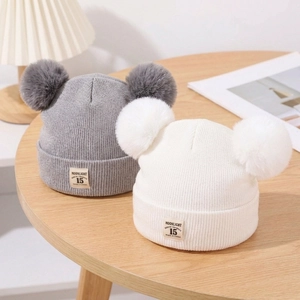 Knit baby beanie hats in grey and white with double faux fur pom poms and vintage patch