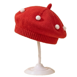 Cute red knitted baby beret with white pom-poms for spring and autumn style