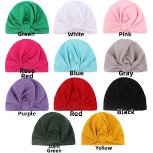 Selection of eleven colorful knotted baby turbans in soft knitted fabric for toddlers