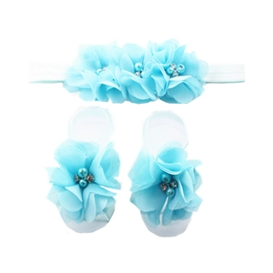 Detail of baby headband and barefoot sandals set with sky blue chiffon flowers