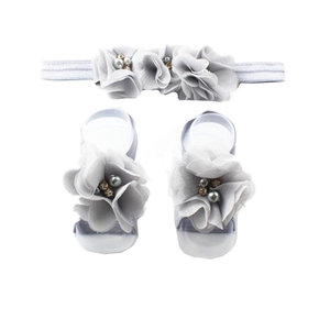 Detail of baby headband and barefoot sandals set with chiffon flowers and rhinestones