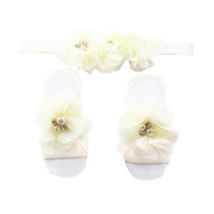Detail view of baby chiffon rhinestone flower headband and barefoot sandals set in beige