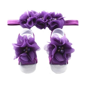 Detailed view of purple chiffon flower headband and barefoot sandal set for infants