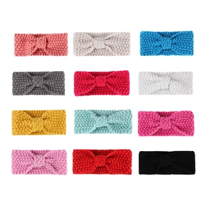 Set of 12 colorful knitted baby headbands with bow design in a organized grid layout