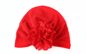 Détail du turban rouge pour bébé avec fleur découpée au laser et tissu tricoté extensible