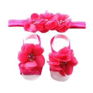 Detailed view of magenta chiffon flowers with pearls and rhinestones on baby headband set