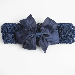Detail view of navy blue elastic crochet baby headband with ribbed texture bow