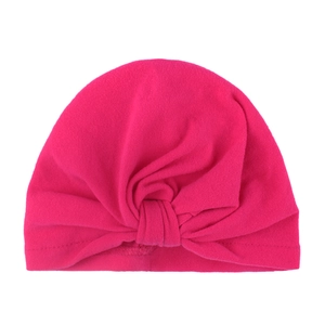 Detailed view of magenta knot detail on soft knit cotton Indian style baby turban cap