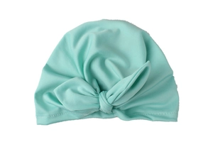 Detail of mint green baby turban hat with a knotted rabbit ear bow in soft cotton