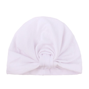 Detail view of soft white cotton baby turban hat with a classic knotted bow design