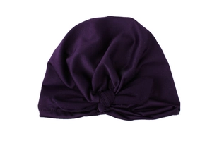 Detail of soft dark purple baby turban hat with large decorative knotted rabbit ears bow