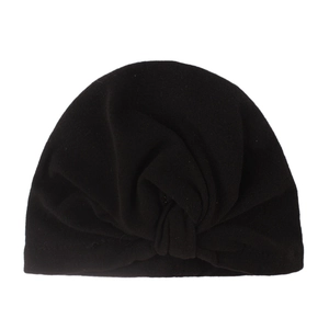 Detail of black infant turban hat featuring a central knot and elastic pleated fabric
