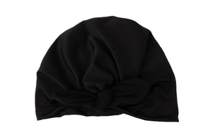 Detail of black knit baby hat with rabbit ear knot and fine textured fabric material