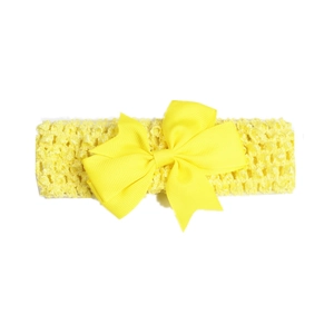 Detail of bright yellow wide elastic headband with a large ribbed ribbon bow for babies
