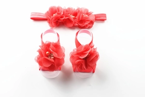 Detail of red chiffon flower baby headband and barefoot sandals set with rhinestones