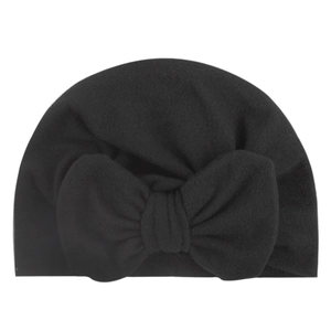 Detailed view of the soft black knit baby hat featuring a large decorative bow