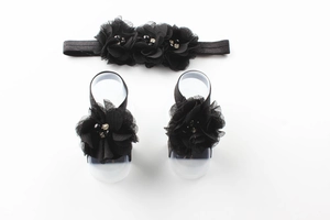 Detail of baby set with black chiffon flower headband and barefoot sandals with pearls