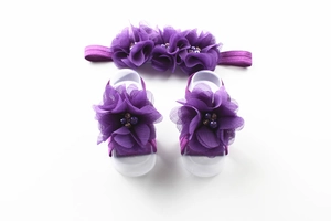 Detail of purple chiffon flower headband and barefoot sandals set with bead centers