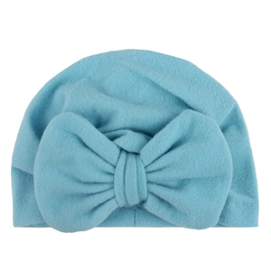 Light blue baby beanie hat with large bow decoration made of soft warm velvet fabric