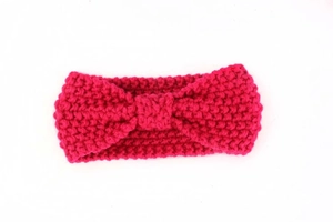 Detail of chunky knit baby headband in rose red with bohemian twist knot texture