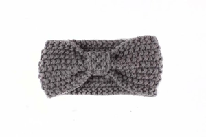 Detail of dark grey cable knit pattern and bow knot on baby winter headband
