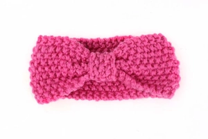 Detailed close-up of dark pink cable knit texture on a winter bohemian baby headband