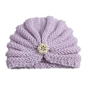 Close-up of lavender knit baby hat with pearl and rhinestone flower cluster detail