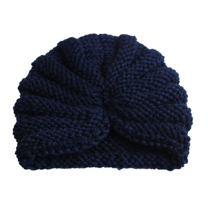 Detail of navy blue chunky knit baby turban hat with a stylish knotted twist design