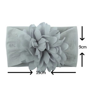 Detail view of a 15cm grey nylon baby headband featuring a 9cm tiered fabric flower