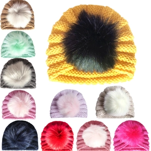 Collection of baby winter knit hats with large pom poms in eleven diverse vibrant colors