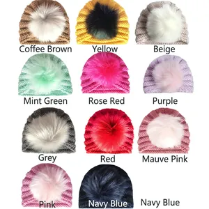 Grid view showing eleven colors of knit baby hats with fluffy faux fur pom-poms