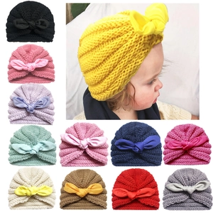 Knitted infant turban hat with large bow decoration available in eleven diverse colors