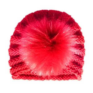 Detailed knit texture of red winter baby hat featuring a large faux fur fluffy pompom