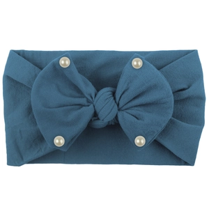 Close-up of soft lake blue nylon baby headband with large bow and white pearls details