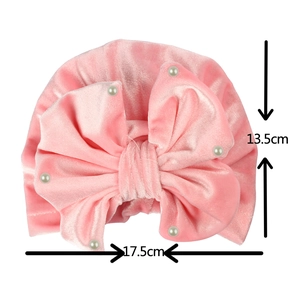 Pink velvet baby turban hat with pearls and bow showing 17.5cm width and 13.5cm height