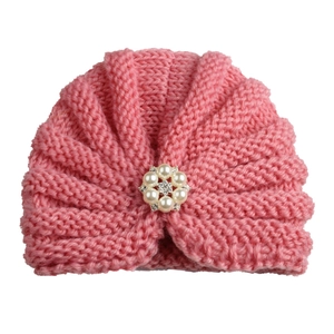 Pink knitted baby turban hat featuring a pearl and rhinestone flower embellishment