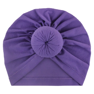 Detailed view of dark purple baby turban hat with a central soft donut knot decoration