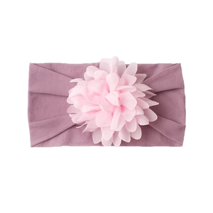 Detail of baby headband with pale pink chiffon flower on light purple nylon fabric