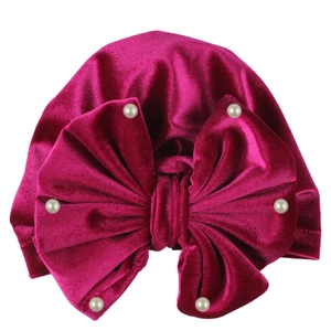 Fuchsia velvet baby turban hat with a large bow and decorative white pearls