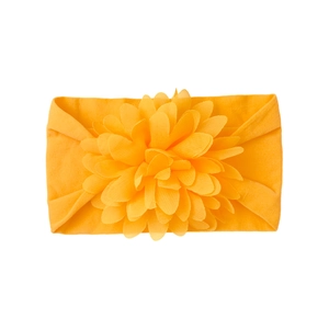 Detailed close-up of a vibrant orange baby nylon headband with a large layered chiffon flower
