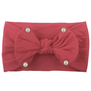 Detail of rose red nylon headband with large soft bow and shiny pearl accents