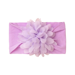 Detail of lavender purple baby headband featuring a soft knit texture and layered silk flower