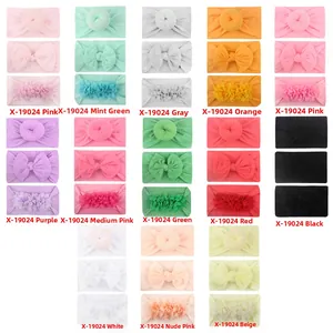 Detail of 12 colors of soft nylon baby headbands with bow, donut and flower styles