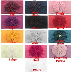 Détail de 13 bandeaux bébé en nylon coloré avec grandes fleurs en tissu et perles