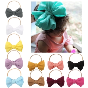 Set of 12 colorful nylon baby headbands with large textured bowknots for infant girls
