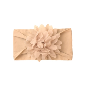 Detail view of champagne nylon baby headband with soft multilayered fabric flower ornament